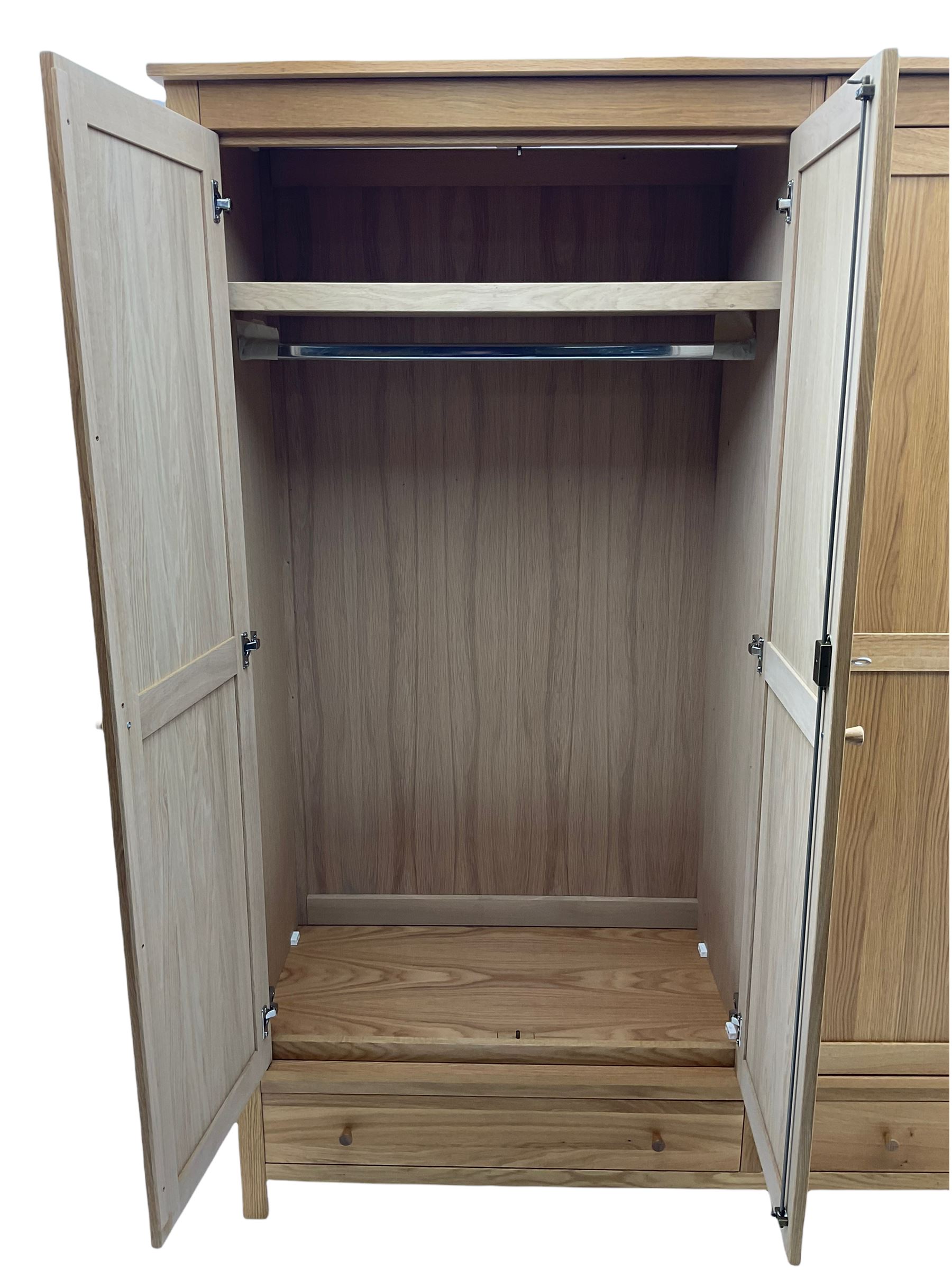 Corndell Furniture - light oak triple wardrobe, enclosed by three panelled doors, one long and one short drawer