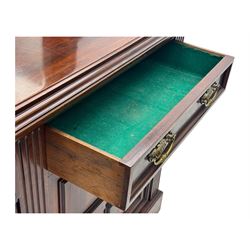 Victorian mirror back press, the arched corniced mirror back flanked by half columns, the base fitted with three drawers and four moulded panel doors with geometric detail, on a block plinth