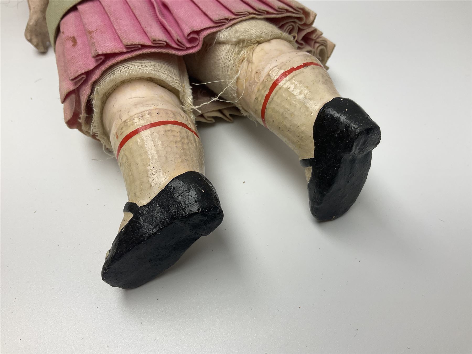 Victorian wax shoulder head doll with applied hair, inset glass eyes and jointed body with composition lower limbs; faded pink dress H35cm