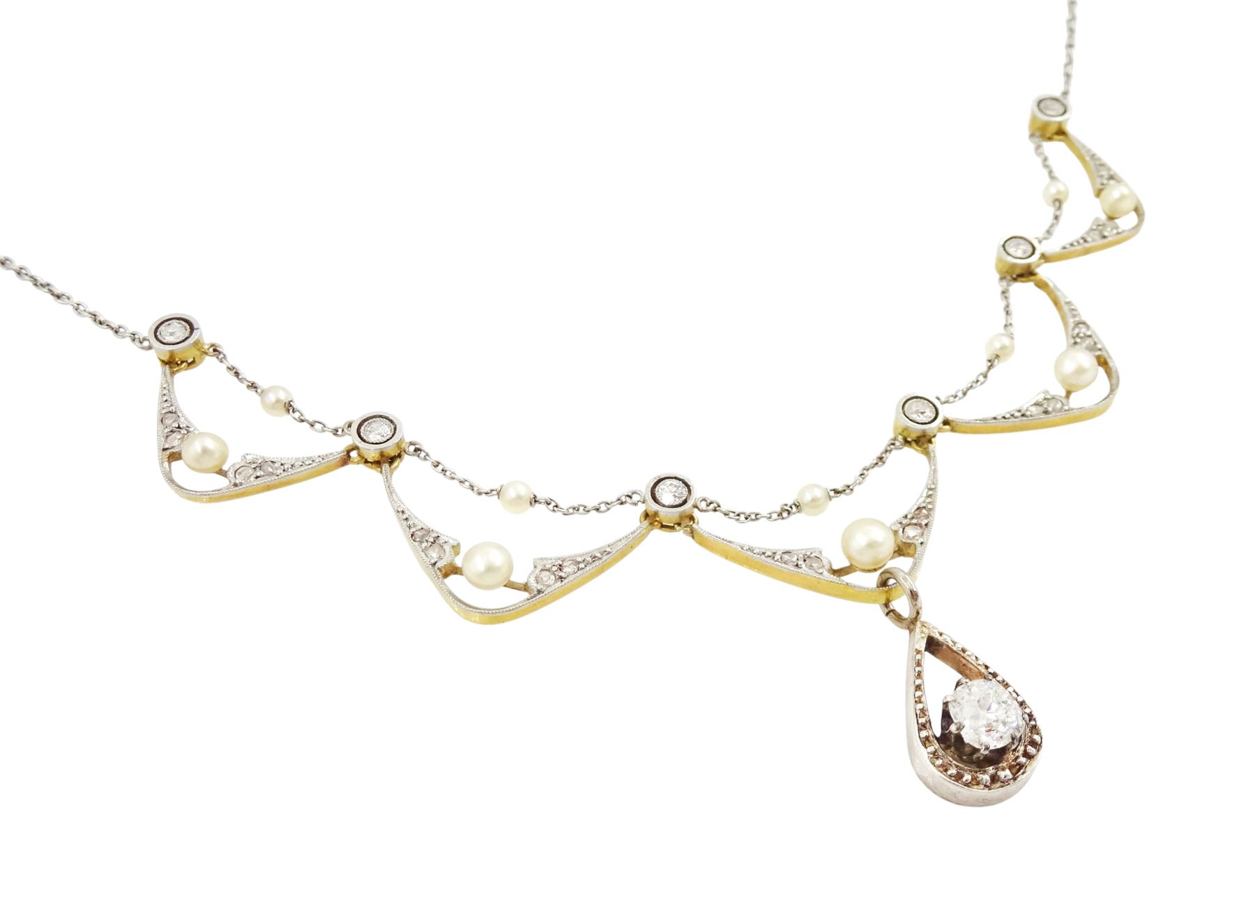 Early 20th century 18ct gold and platinum diamond and pearl necklace, five central fancy swag links, milgrain set with rose cut diamonds and a single pearl, with a trace link pearl top, each spaced by an old cut diamond, the central link suspending an old cut diamond of approx 0.55 carat, to a platinum trace link chain necklace, total diamond weight approx 0.75 carat