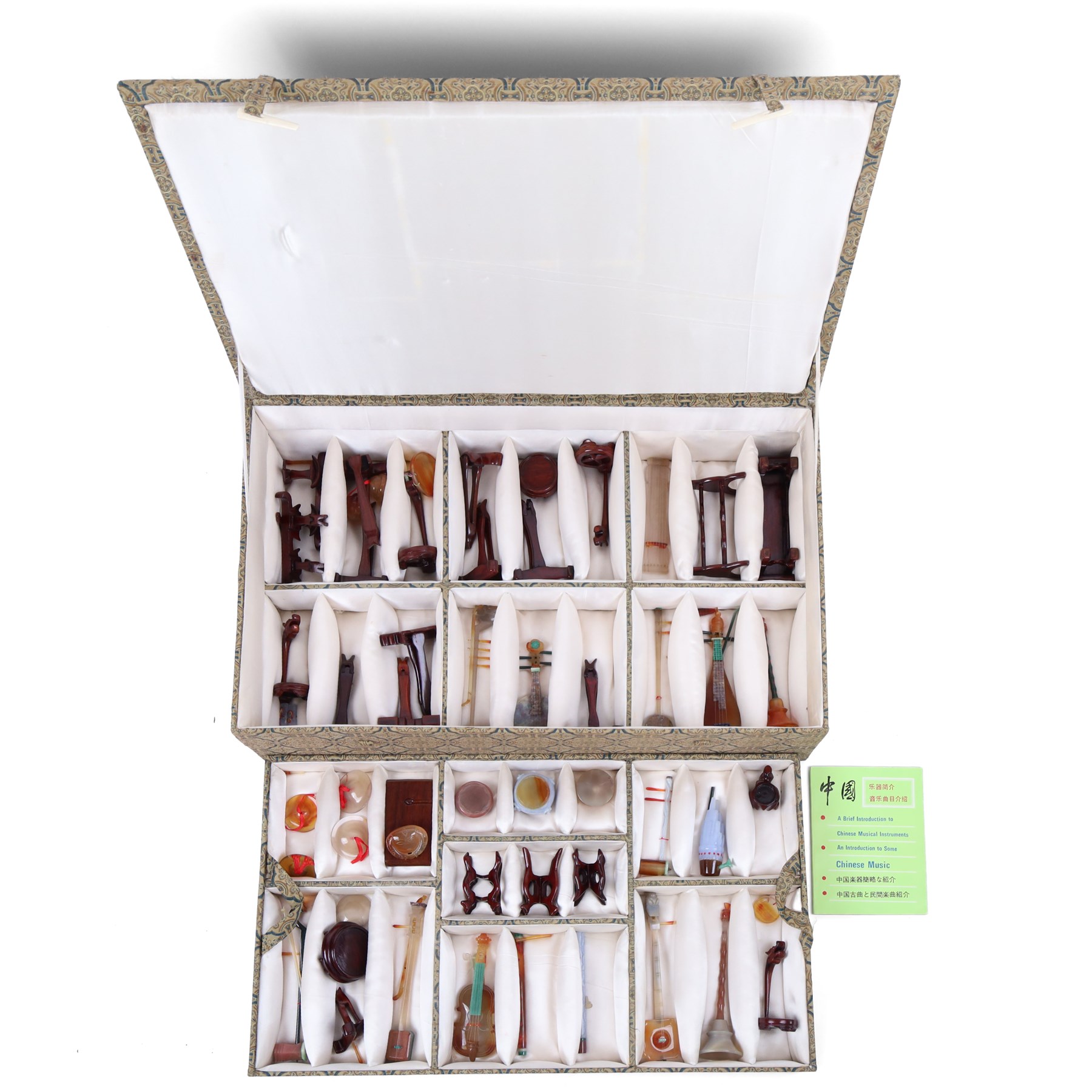Boxed set of Chinese miniature polished hardstone musical instruments with hardwood stands