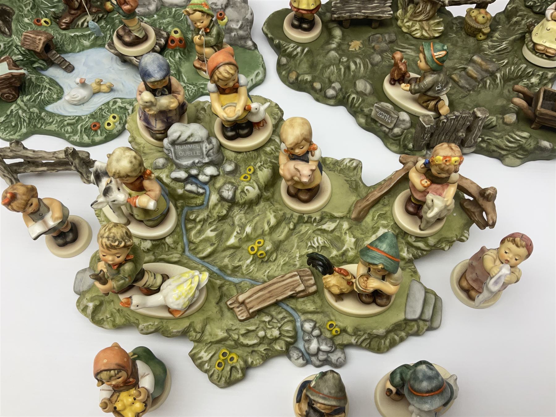 Collection Hummel figures by Goebel, together with three hummel landscapes, Hummel Quelle, Hummel Weiher and Hummel Garten