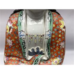 Tall Chinese polychrome figure of Guanyin (Guan Yin), the Goddess of Mercy and compassion, the Bodhisattva modelled seated and holding a rosary donning elaborate floral robes and beads, with four character seal marks beneath, H53cm