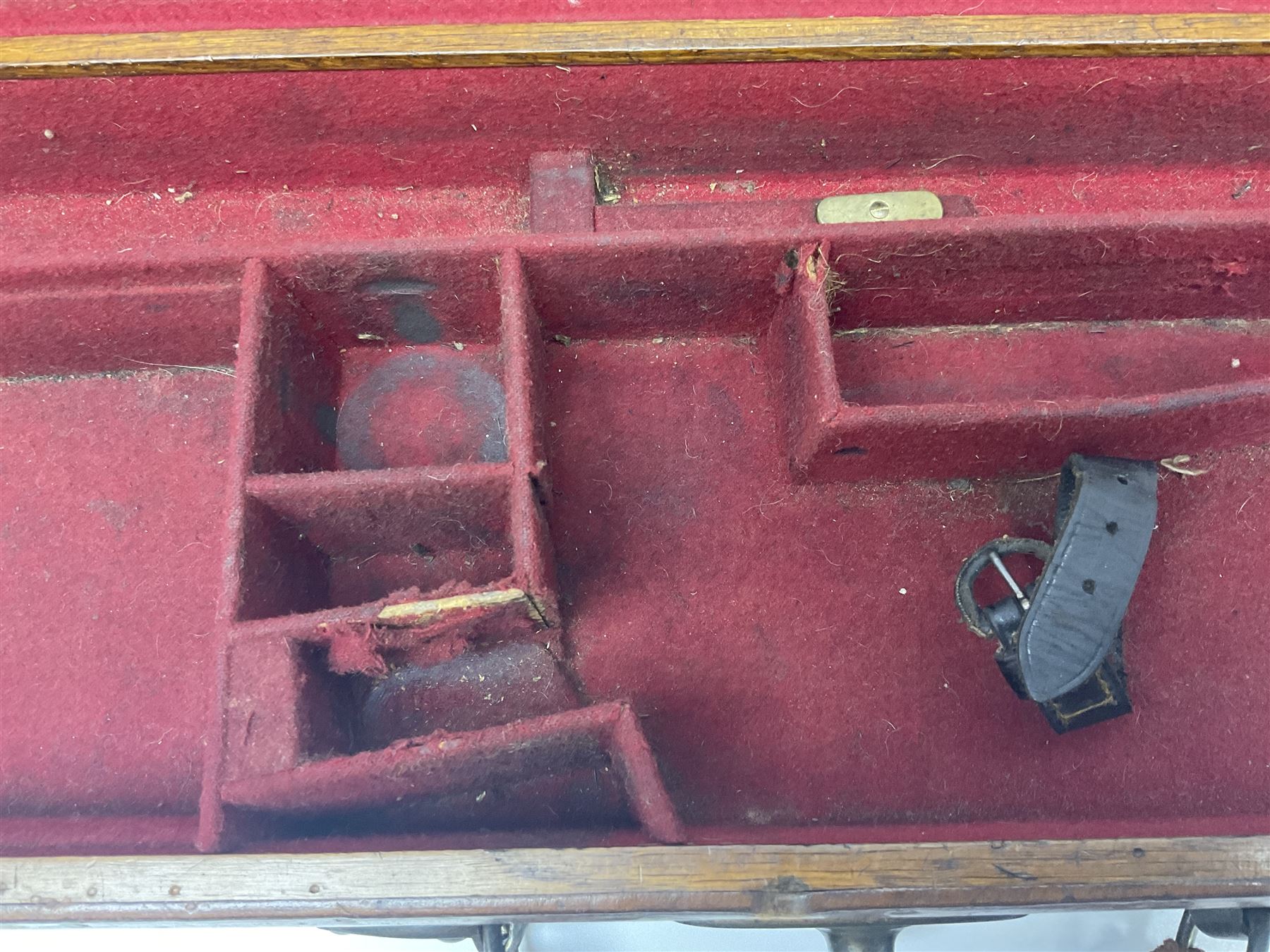 Leather shotgun case, the red baize lined interior with the trade labels of Westley Richards & Co., London, a brass plaque inscribed 'T Nevin, Mirfield, Yorkshire' to cover, with key, case to fit barrel 76cm (30 inches)  
