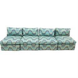 Parker & Farr - 1970s modular sofa suite comprising four chairs and footstool, reclined back with loose seat cushion, upholstered in turquoise flame-stich fabric with skirt, on castors
