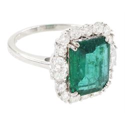 18ct white gold emerald and diamond cluster ring, the octagonal cut emerald of approx 2.85 carat, with an oval cut diamond set either side and round brilliant cut diamond surround, stamped, total diamond weight approx 1.05 carat