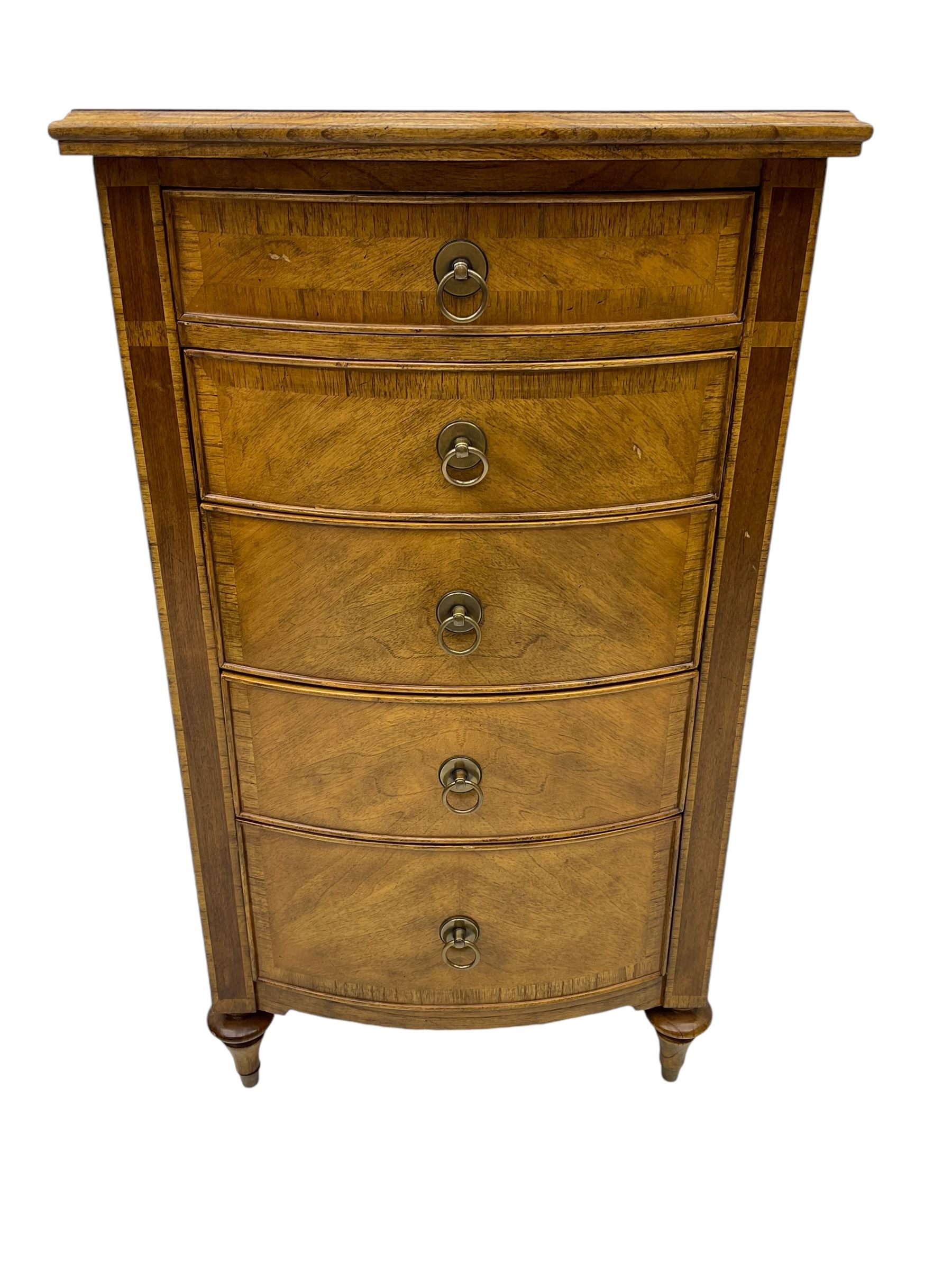 Frank Hudson - mid-20th century Mindi ash and burr walnut bow-fronted lingerie chest, crossbanded hinged top concealing vanity mirror, over five graduated cockbeaded drawers, raised on turned supports