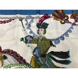 Hermès 'Le Timbalier' silk scarf, designed by Francoise Heron in 1961, printed with a central image of a gentleman on horseback donning extravagant dress, on white ground surrounded with colourful stylised knotted ropes, contained within peacock blue border, with rolled hand stitched edges and Hermes material label, 87cm square