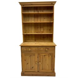 Traditional pine dresser, raised back fitted with adjustable shelves, the base with two drawers over double cupboard, plinth base
