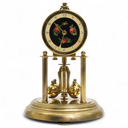 1960’s torsion clock with a skeleton movement and four ball oscillating pendulum, with a glass dome