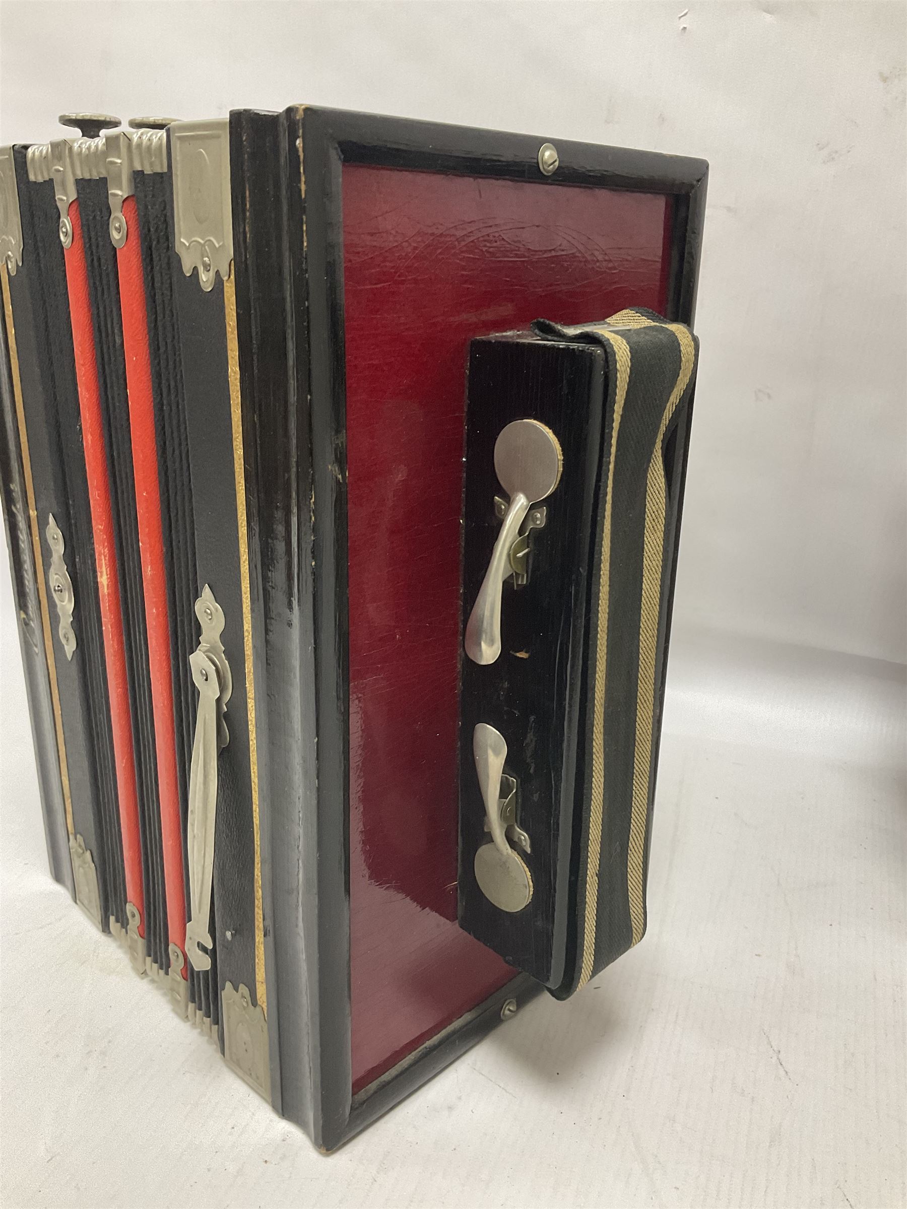 Three European concertinas, comprising Viceroy German concertina with 21 keys, hexagon wooden frame and 8 fold bellows
Oak framed concertina with 12 keys and 8 fold bellows
Commander concertina with 12 keys and 12 fold bellows
With tutor