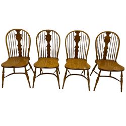 Set of four light elm stick back chairs, figured Windsor splat back, saddle seat, crinoline stretcher base
