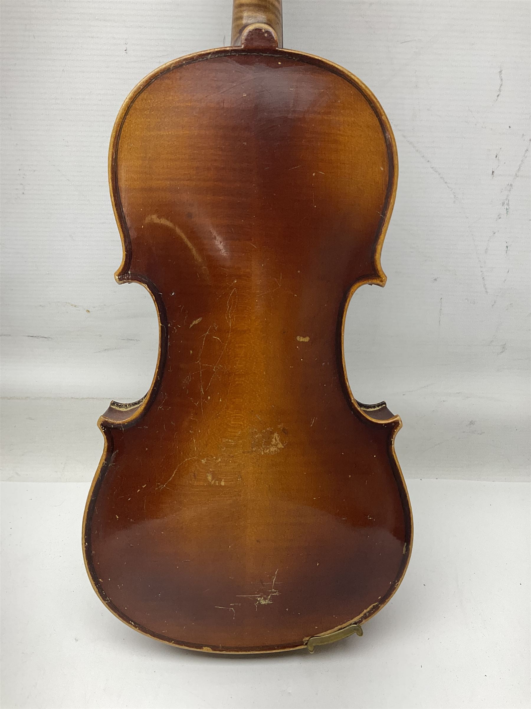 Czechoslovakian violin c1920 with 36cm two-piece maple back and ribs and spruce top, bears label 'Copy of Antonius Stradivarius Made in Czechoslovakia' L59cm; in carrying case; 1950s Czechoslovakian violin; and 195os Czechoslovakian three-quarter size violin; both cased (3)