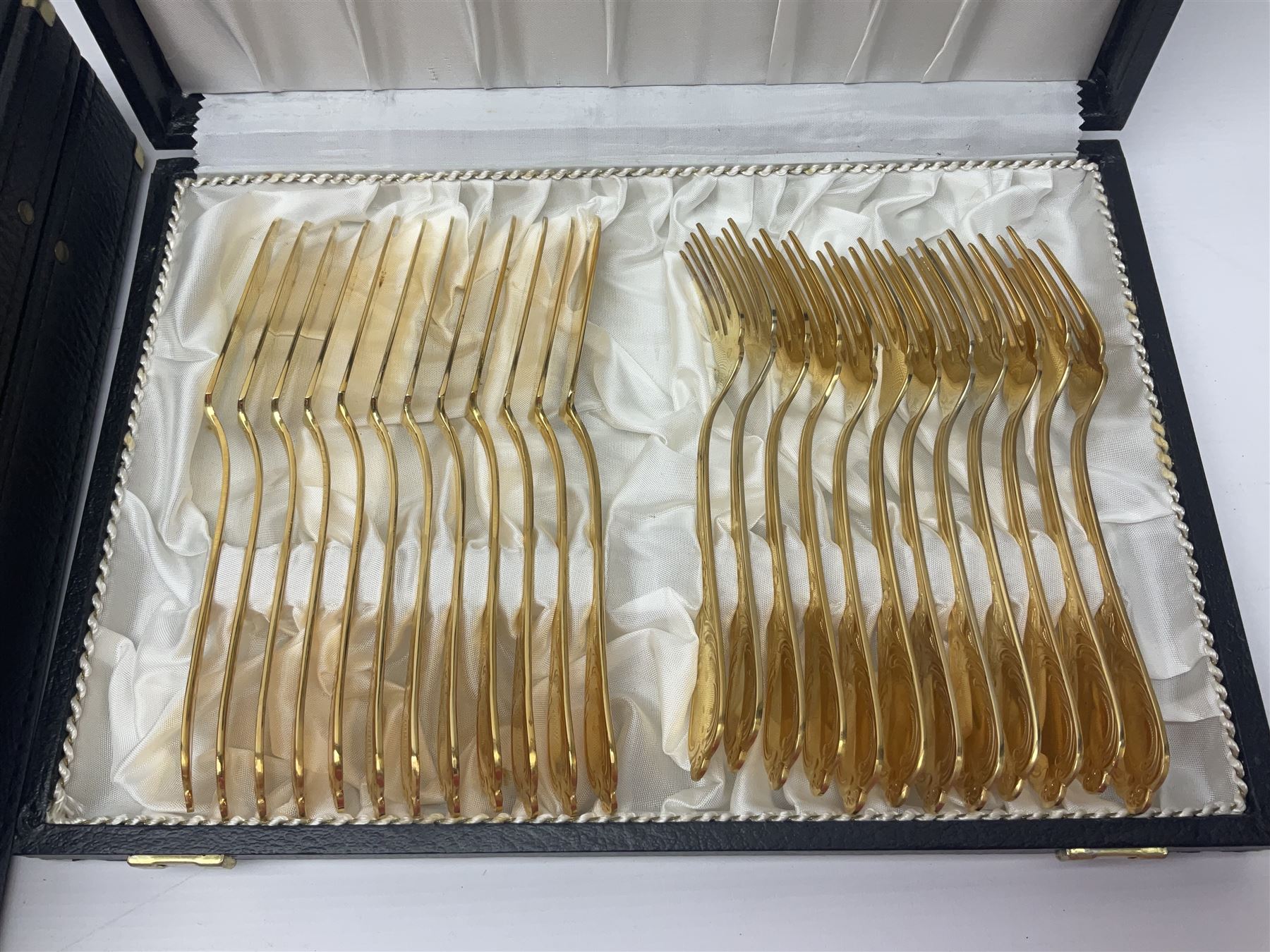 Bestecke Solingen canteen of gold plated cutlery for twelve place settings, including ladle, cake slice and serving spoons, contained within a briefcase, together with a matching set twelve of Bestecke Solingen gold plated fish knives and forks, in fitted case 