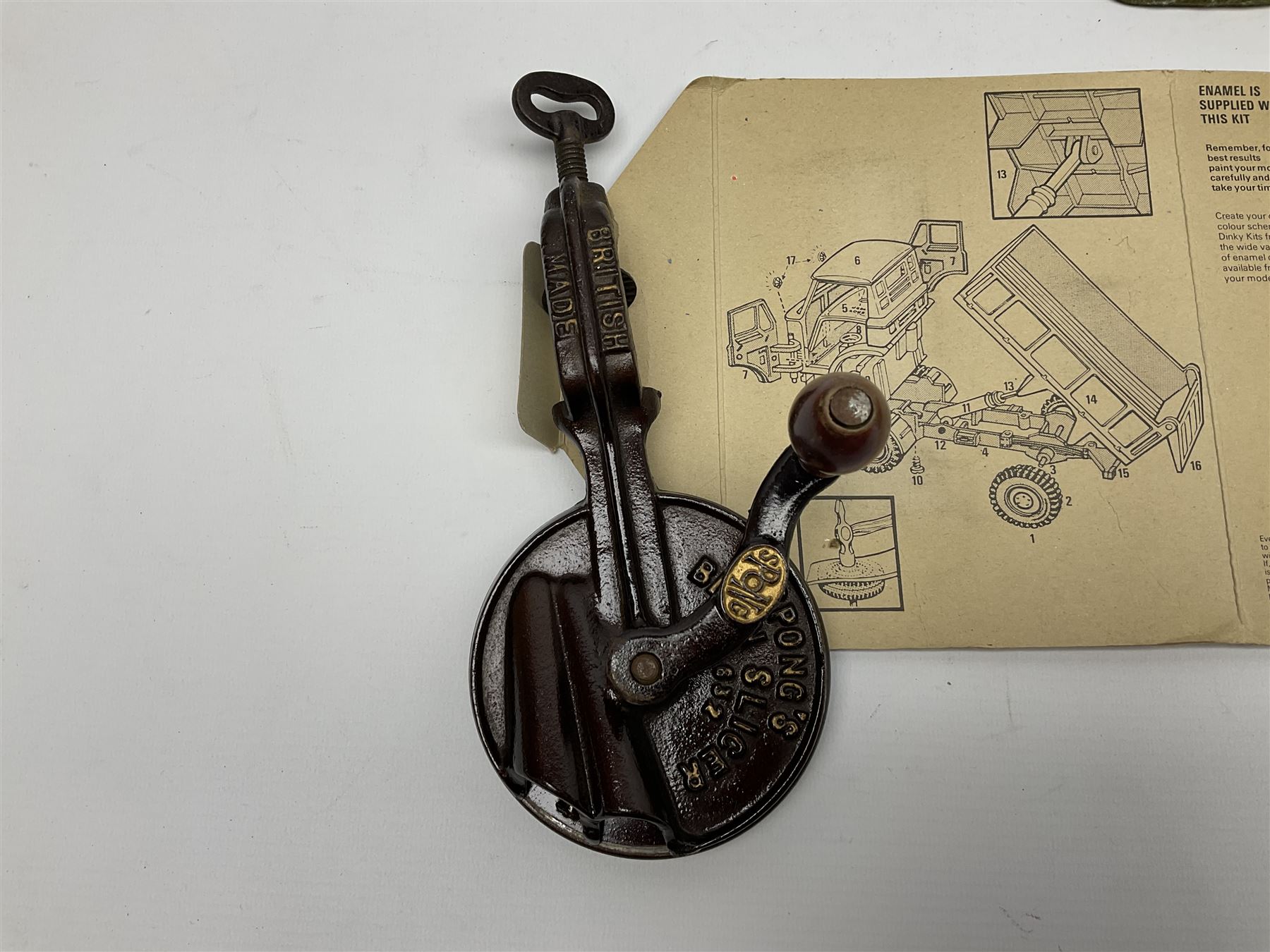 Dinky Kit No.1029 Ford D800 Tipper Truck in unopened original packaging; American Singer child's sewing machine; Spong's table mounting Bean Slicer No.632; and two wall mounting wooden die-cast model open display racks (5)