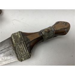 Saudi Arabian khanjar dagger with 29.5cm curving double edged  steel blade; white metal and copper mounted horn grip; in white metal mounted brass and leather scabbard incorporating embroidered leather wearing strap