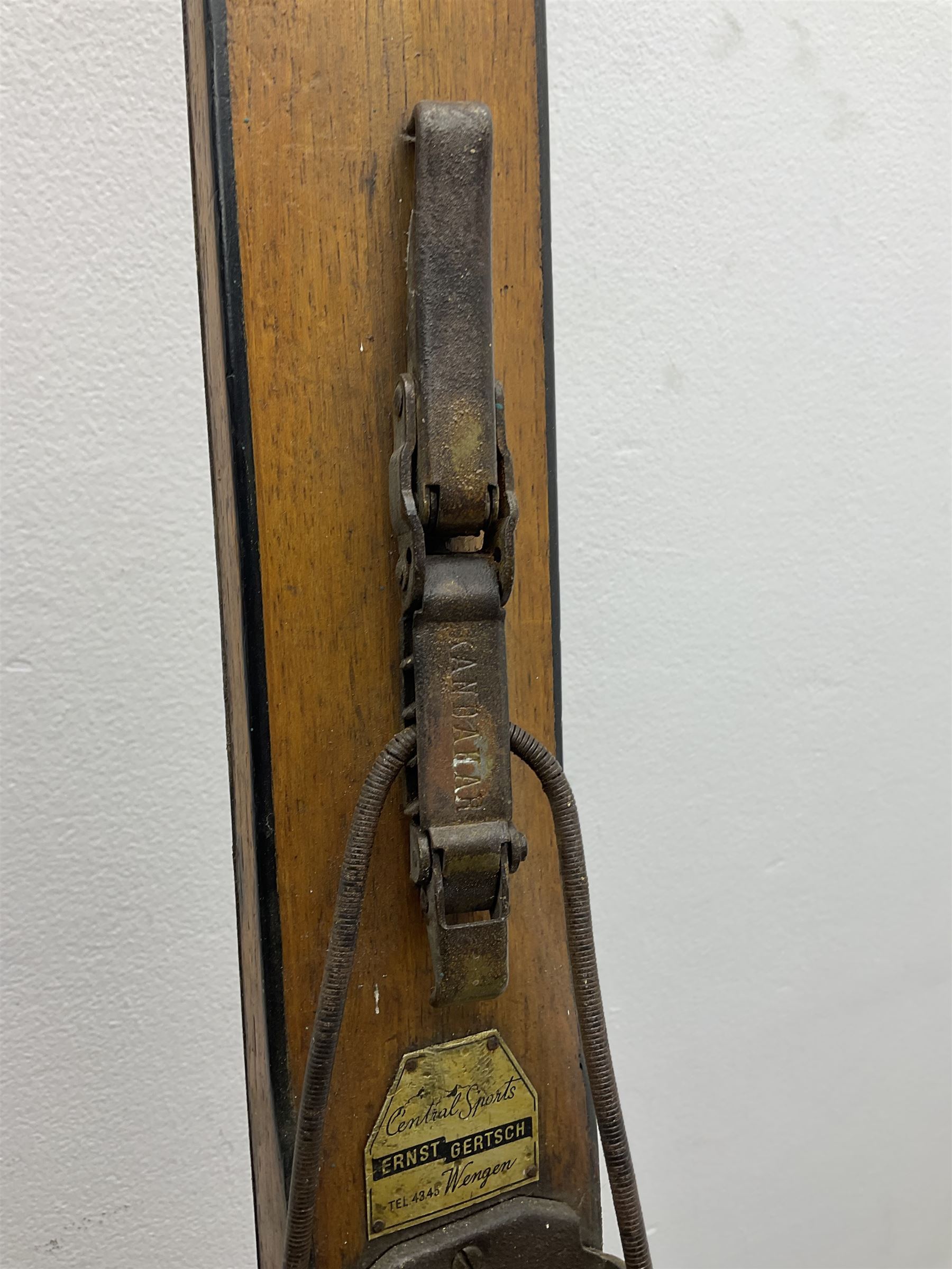 Pair of 1930s wooden skis, with painted metal runners beneath stamped Attenhofer, with retailers label for Ernst Gertsch Central Sports, L206cm