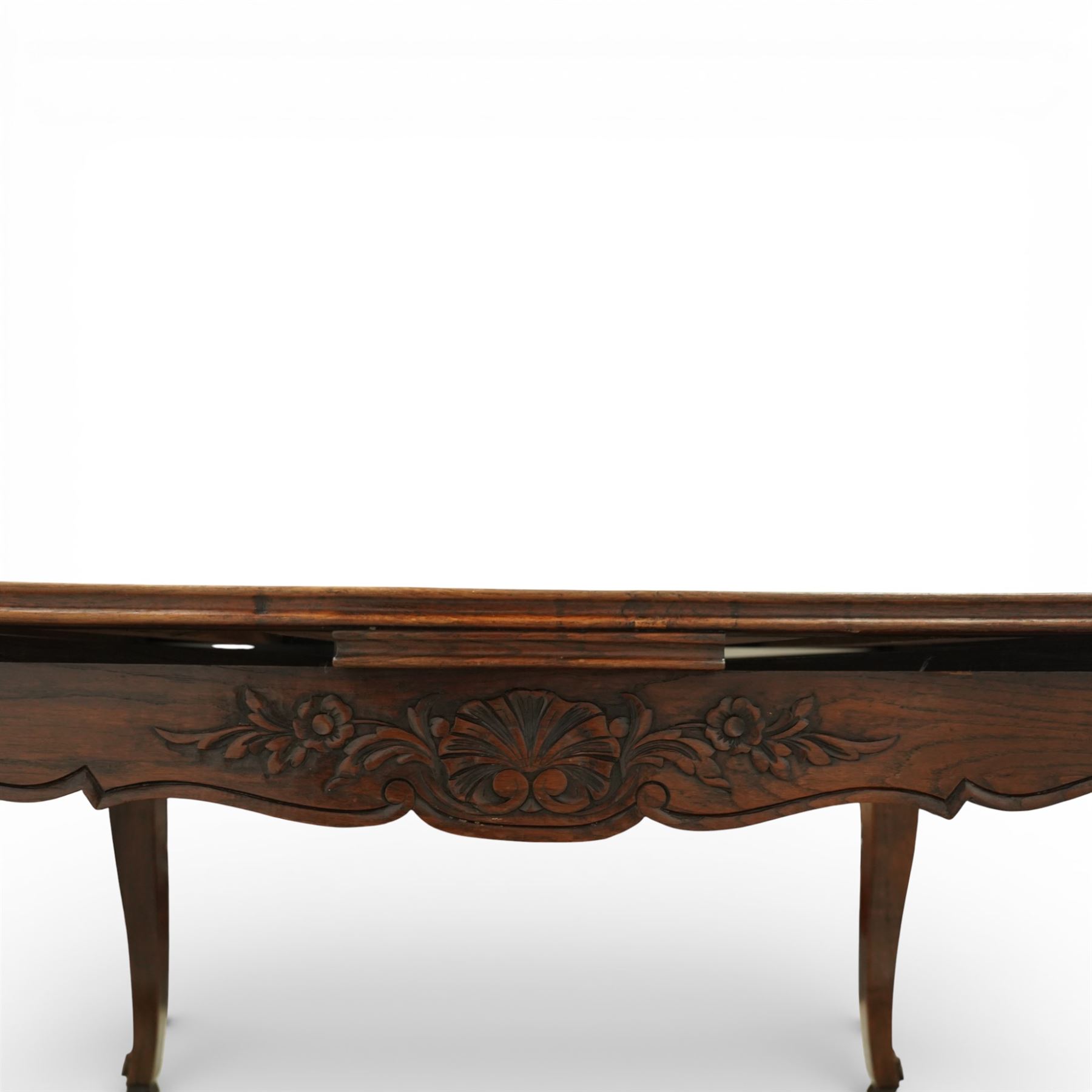 20th century French oak drawer-leaf extending dining table and six chairs, the rectangular parquetry top with moulded edge and rounded corners, pull-out draw leaves extending the table to 240cm, carved frieze with foliate detail, raised on cabriole supports with scroll terminals, the six matching chairs with shaped backs carved with floral motifs, paper cord seats woven with a green pattern, cabriole front supports and turned stretchers