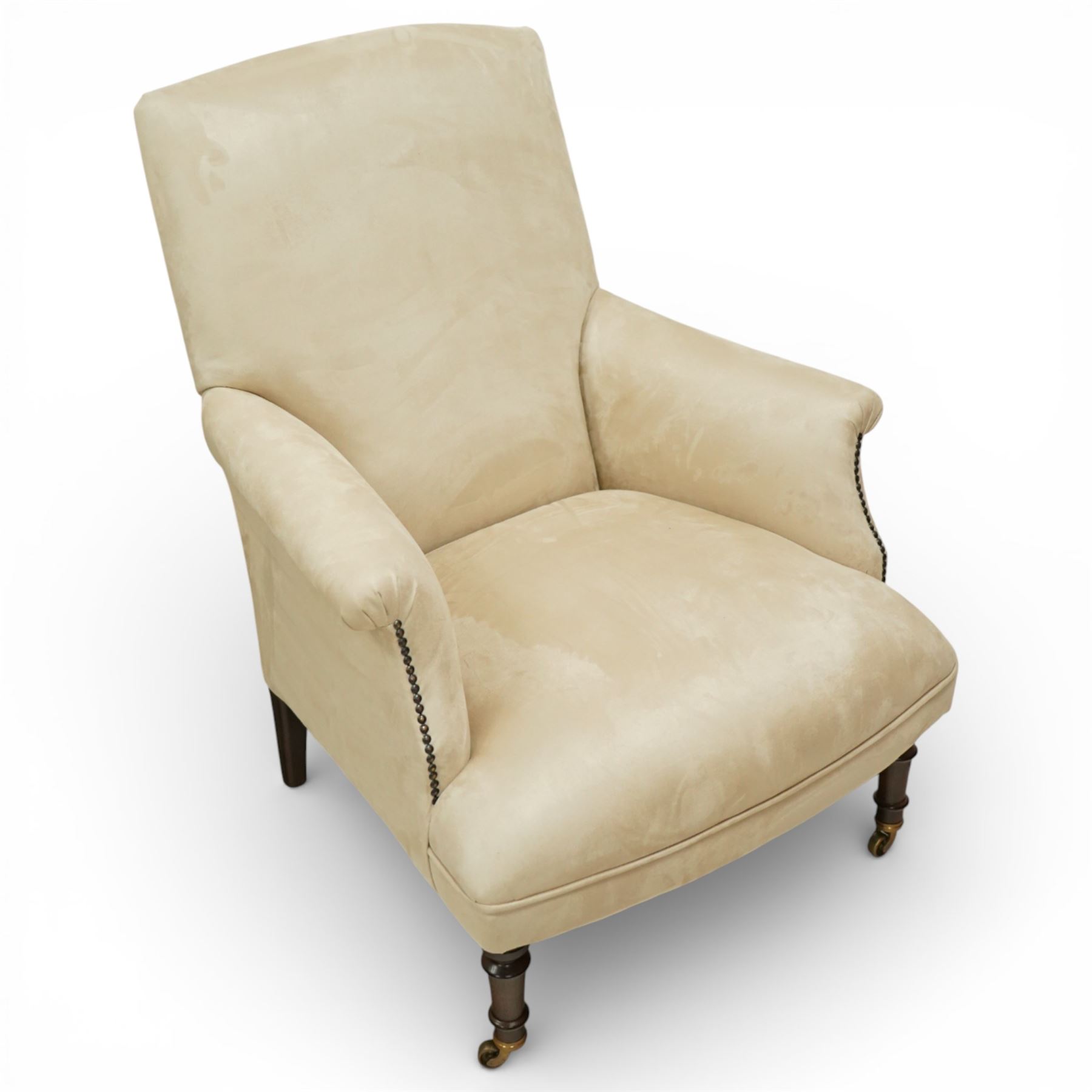 Sofas & Stuff - pair of ‘Thistle’ armchairs upholstered in neutral fabric, each with gently sloping back, padded scroll arms with close-set stud detailing, loose seat cushions, raised on turned wooden legs with brass castors