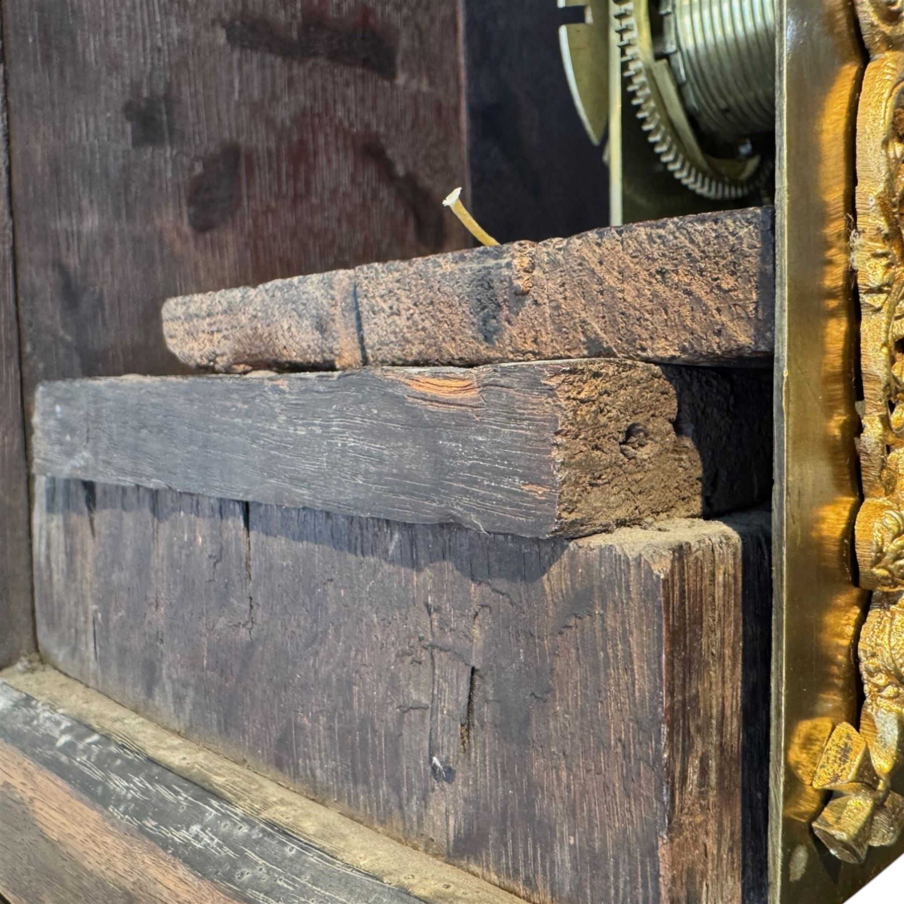 Henry De La Feuille of London-early 18th century marquetry 8-day longcase clock c 1720, hood with a moulded upstand to the domed caddy top, set on a lower upstand above a wide cornice with a marquetry frieze beneath, square hood door with marquetry inlay and attached three-quarter columns with wooden capitals, hood sides with glazed panels, trunk and door inlaid with figural marquetry with various representations of people, birds, scrollwork and foliage, full length door with cock-beading surround and a circular glazed lenticle, the case sides veneered with bordered panels within crossbanded surrounds, plinth with a convex moulding and shallow moulded skirt, brass dial with a matted centre and ringed winding holes, date aperture and seconds dial, silvered chapter with Roman numerals, five minute Arabic’s, minute and inner quarter hour tracks and half-our markers, with pierced steel hands and matching cast scroll spandrels depicting angels supporting a crown, dial pinned directly to a four pillar movement with an outside countwheel and recoil anchor escapement, striking the hours on a cast and polished bell.
With weights, pendulum and key.

Henry De La Feuille was a French Huguenot, born in 1670, moving to Jersey c1690 and finally London where he is thought to have died c1730.
