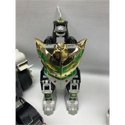 Collection of early 90s Mighty Morphin’ Power Rangers Zords, figures and accessories. Titanus the Carrier Zord, marked Bandai 1991; Green Dragonzord, incomplete; 1994 White Tigerzord with original instruction manual; 1993 Triceratops Dinozord, Mastodon Dinozord and Sabertooth Tiger Dinozord, Pterodactyl Dinozord, missing guns; with 1993 Power Morpher and original Power Coins, with further related figures, accessories and weapons