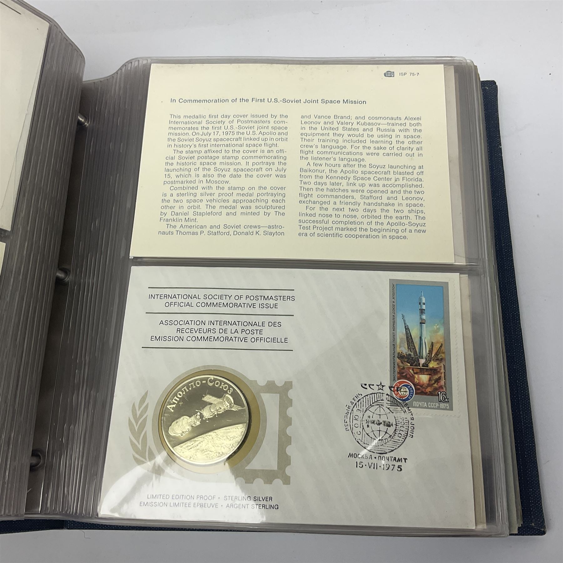 Thirty-one 'International Society of Postmasters Official Commemorative Issues' sterling silver proof medallic covers dating from 1975 to1977, housed in the official folder and a 'Commemorating The Bicentennial Of The United States Of America' sterling silver proof medallic first day cover in blue wallet