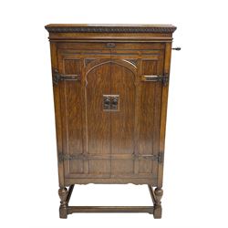 Early 20th century ‘HMV' 202 cabinet gramophone, oak cased, moulded top with foliate carved moulding hinges to reveal gramophone, two doors enclosing horn, on turned supports joined by moulded stretcher rails