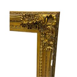 Gilt framed mirror, the frame decorated with cartouche and foliate corners with extending flower heads, inverted sea scrolls from the middle and egg and dart slip, bevelled plate 120cm x 89cm 
