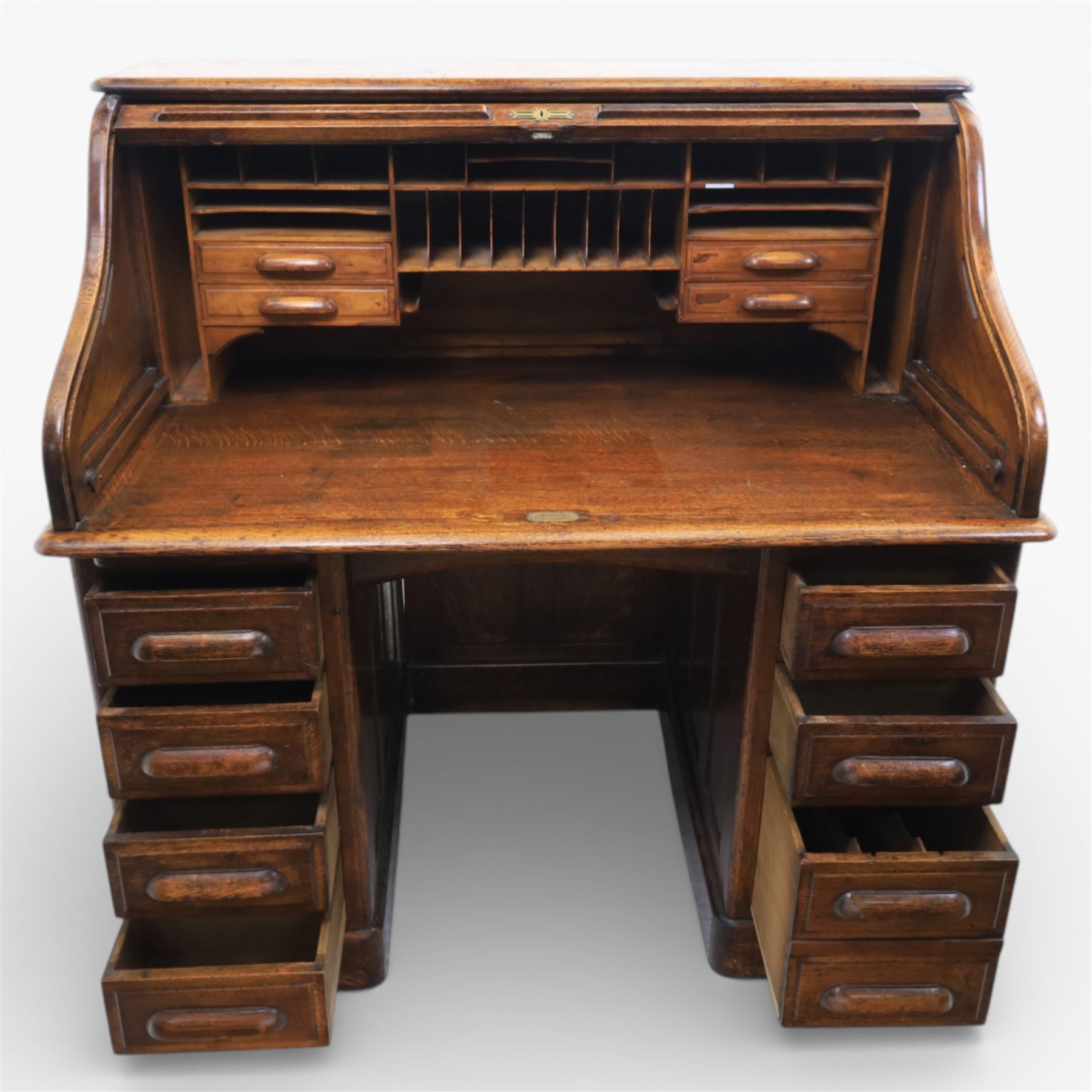 Globe Wernicke - Oak roll top desk, tambour roll top enclosing a fitted interior, raised on two pedestal bases with fitted drawers, raised on a plinth base 