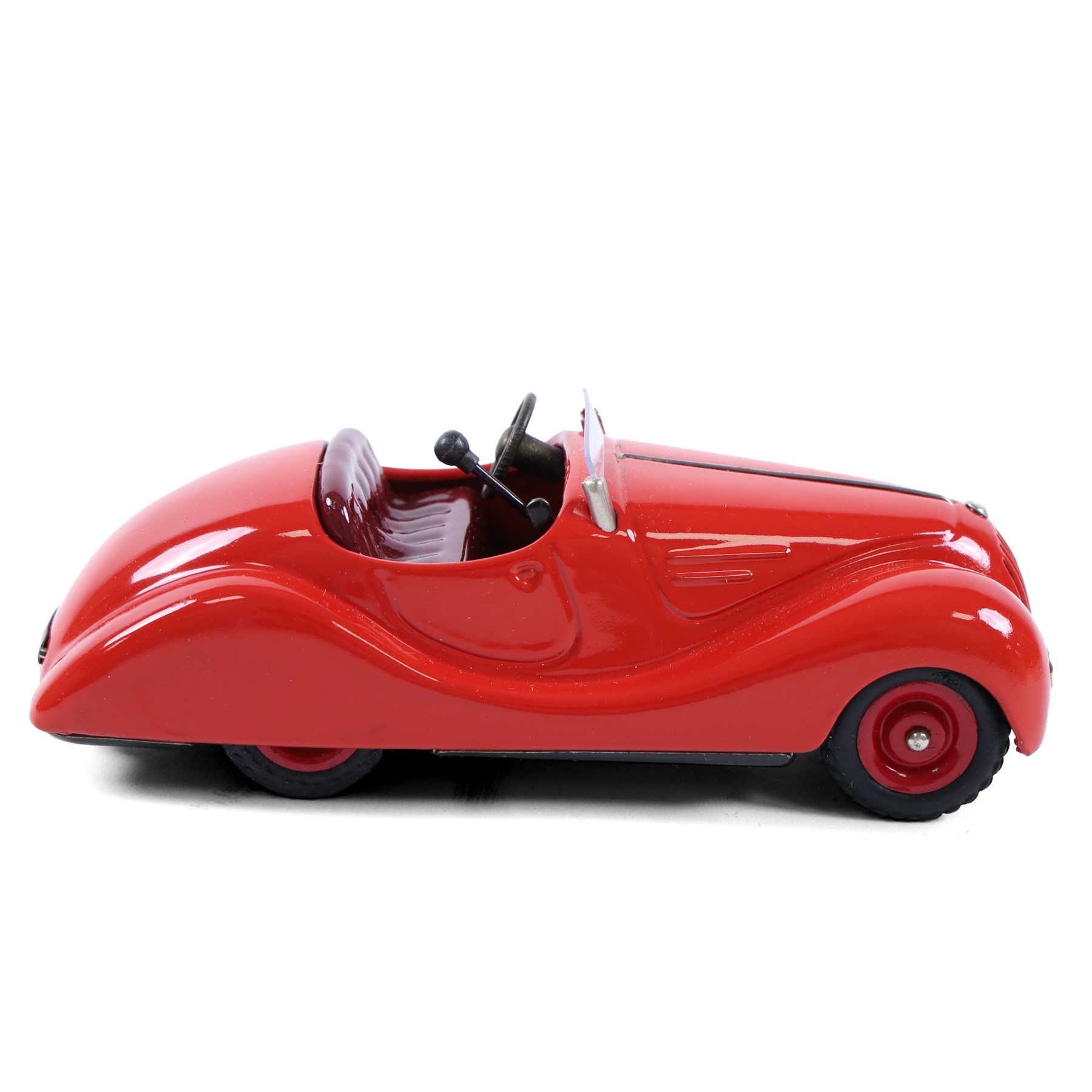 Schuco Examico 4001 tinplate clockwork car, in red with burgundy interior, with key and instructions, boxed