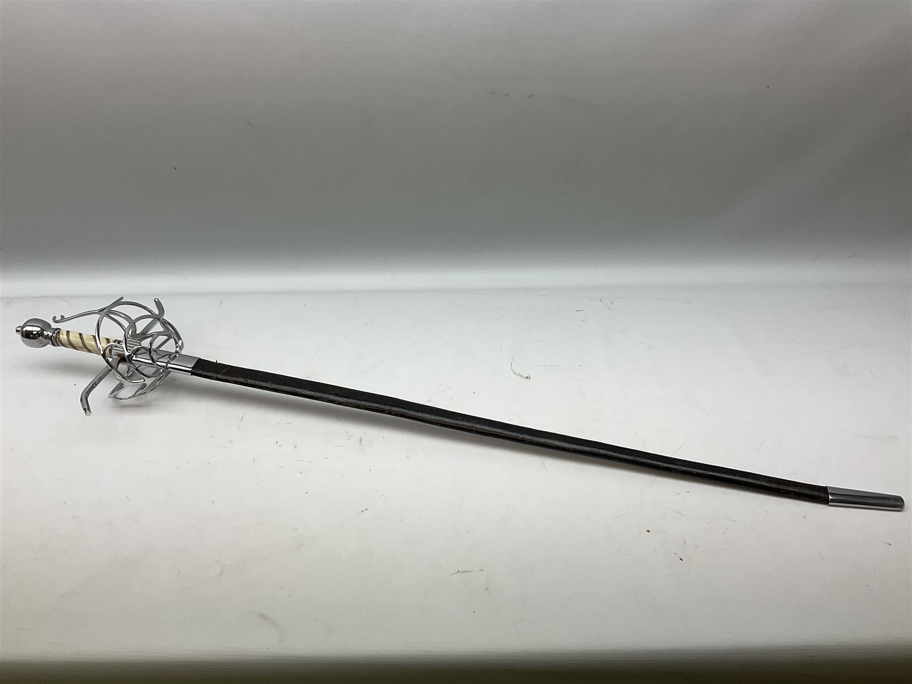 Replica knight's longsword, the 91.5cm double-edged steel blade with basket hilt and wire-bound bone grip with spherical pommel, in leather scabbard L112cm overall