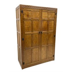 'Gnomeman' oak double wardrobe, enclosed by two panelled doors, the interior fitted with hanging rail, panelled sides and adzed all over,