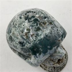 Carving of a skull in moss agate, H9cm, L12cm 