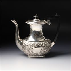 Late Victorian four piece silver tea set comprising teapot, coffee pot, sugar bowl and milk jug with embossed decoration, the cartouches engraved with an initial, the teapot and coffee pot Chester 1899 Maker George Nathan & Ridley Hayes, the sugar bowl and milk jug Birmingham 1899 Maker Thomas Hayes