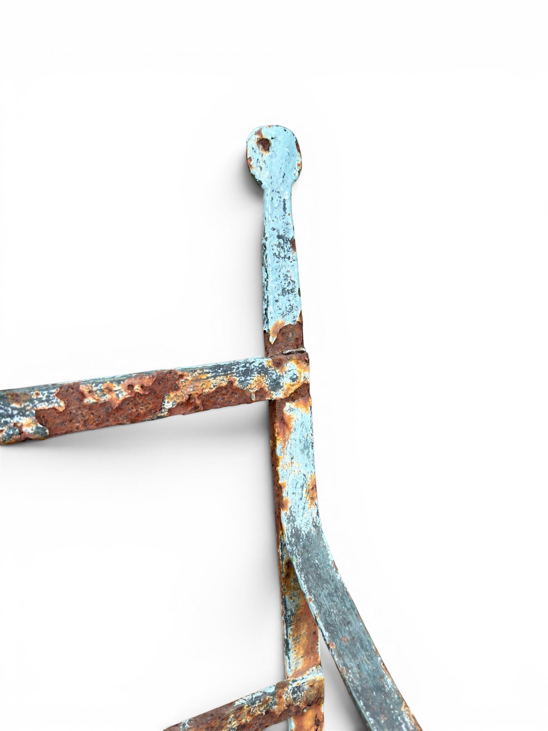 Regency period wrought iron strapwork garden bench, cresting rail with central Scottish thistle motif and flanking pediments, in distressed blue painted finish