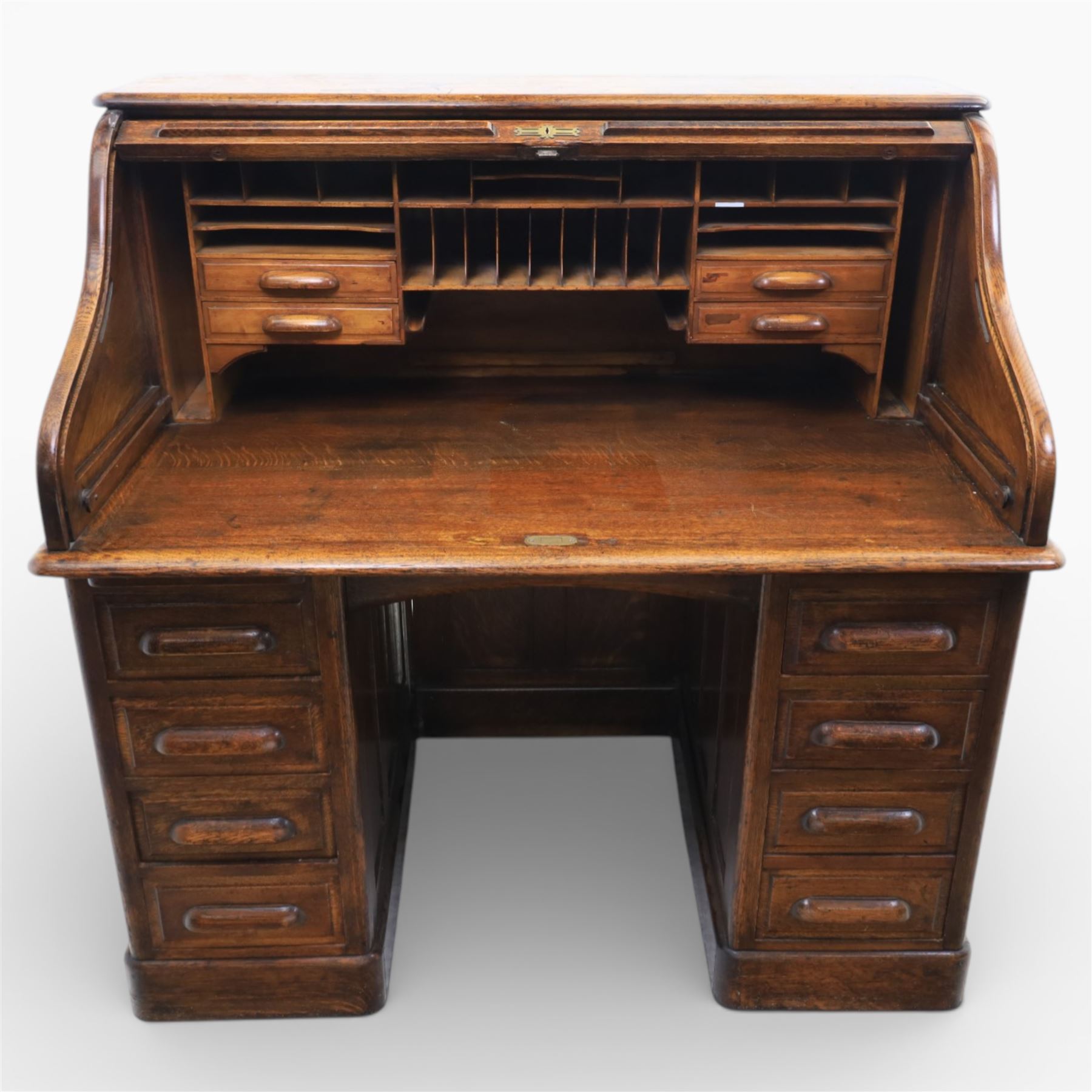 Globe Wernicke - Oak roll top desk, tambour roll top enclosing a fitted interior, raised on two pedestal bases with fitted drawers, raised on a plinth base 
