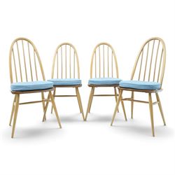 Ercol - set of four 'Quaker' dining chairs, with high hooped back, blue seat cushions with...