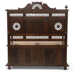 19th century European heavily carved oak hall settle, the impressive high-back with a pierced and carved acanthus pediment, over foliate and rosette carved back rails, flanking a central panel depicting a gentleman on horseback drinking, the hinged box seat over a quadruple panelled front with relief carved busts, lower moulded and carved edge on compressed bun feet