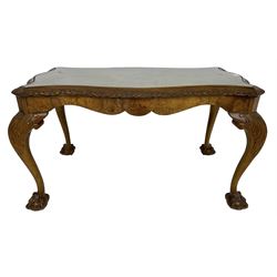 Mid-20th century figured walnut serpentine coffee table, inset glass top and foliate carved edge, raised on cabriole supports with acanthus moulded knees and ball and claw feet