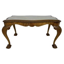 Mid-20th century figured walnut serpentine coffee table, inset glass top and foliate carved edge, raised on cabriole supports with acanthus moulded knees and ball and claw feet