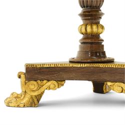 French Empire design rosewood and parcel-gilt occasional table, the circular top with sunburst veneer and giltwood gadrooned edge, raised on a turned and lobed pedestal terminating to a triform platform base with gilt beading, raised on three large paw feet with scrolling foliate brackets