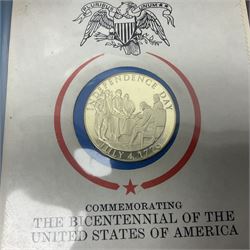Thirty-one 'International Society of Postmasters Official Commemorative Issues' sterling silver proof medallic covers dating from 1975 to1977, housed in the official folder and a 'Commemorating The Bicentennial Of The United States Of America' sterling silver proof medallic first day cover in blue wallet