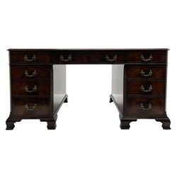 Large Georgian design mahogany twin pedestal partner's desk, moulded rectangular top with canted corners and inset leather writing surface, fitted with nine drawers and two cupboards, the pedestals with canted uprights decorated with blind fretwork, on ogee bracket feet