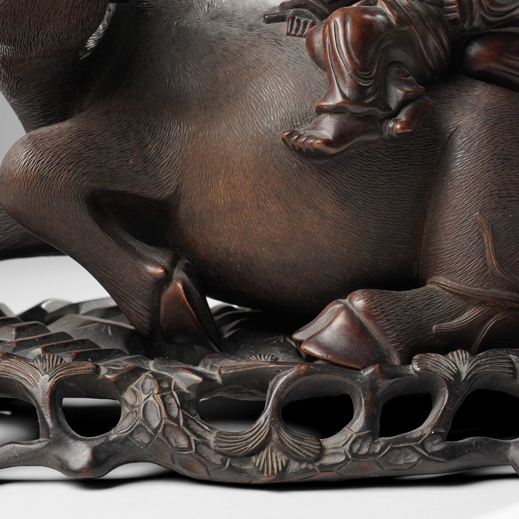 Early 20th century Chinese carved hardwood figural group of two boys on the back of a water buffalo on wooden stand W37cm
