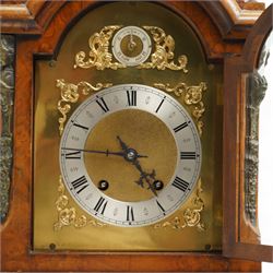 German-early 20th century mantle clock c1910, in a walnut case with a break arch top and decorative cast brass finials, brass silk backed sound frets to the sides and a glazed break-arch door flanked by a pair of cast brass caryatid, on a dee ogee moulded plinth and raised on splayed paw feet, brass dial with cast spandrels and a matted dial centre, silvered chapter ring with Roman numerals, gothic steel hands and a conforming pendulum regulation dial to the arch, two train going barrel movement with rack striking, sounding the quarters on two gongs and the hour on one, With Pendulum and key.
