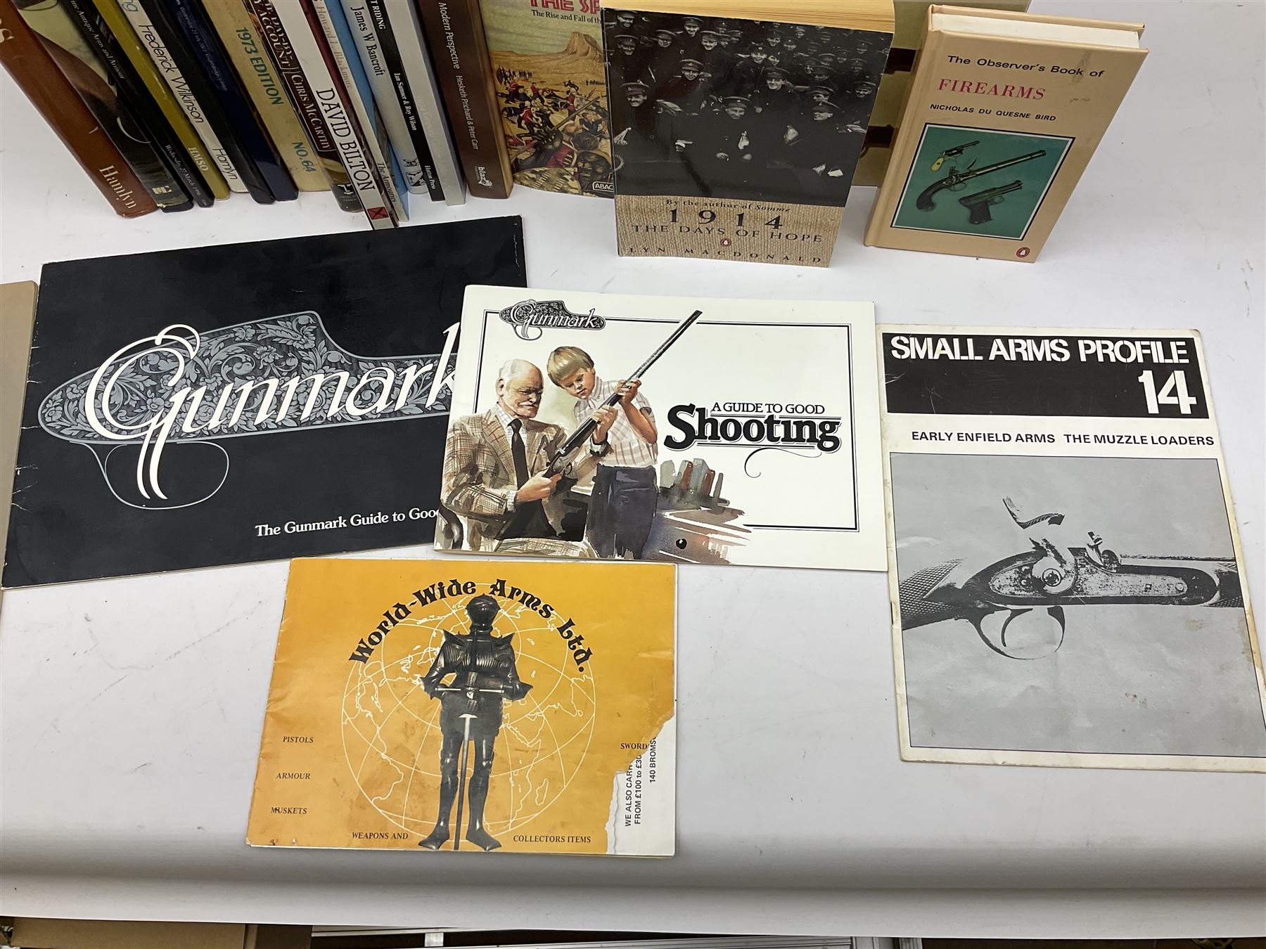 Sixteen books/booklets on guns and shooting including 1969 Holland & Holland Catalogue; two Gunmark Guides to Good Shooting; Shooters Bible 1972 etc; and small quantity of militaria books