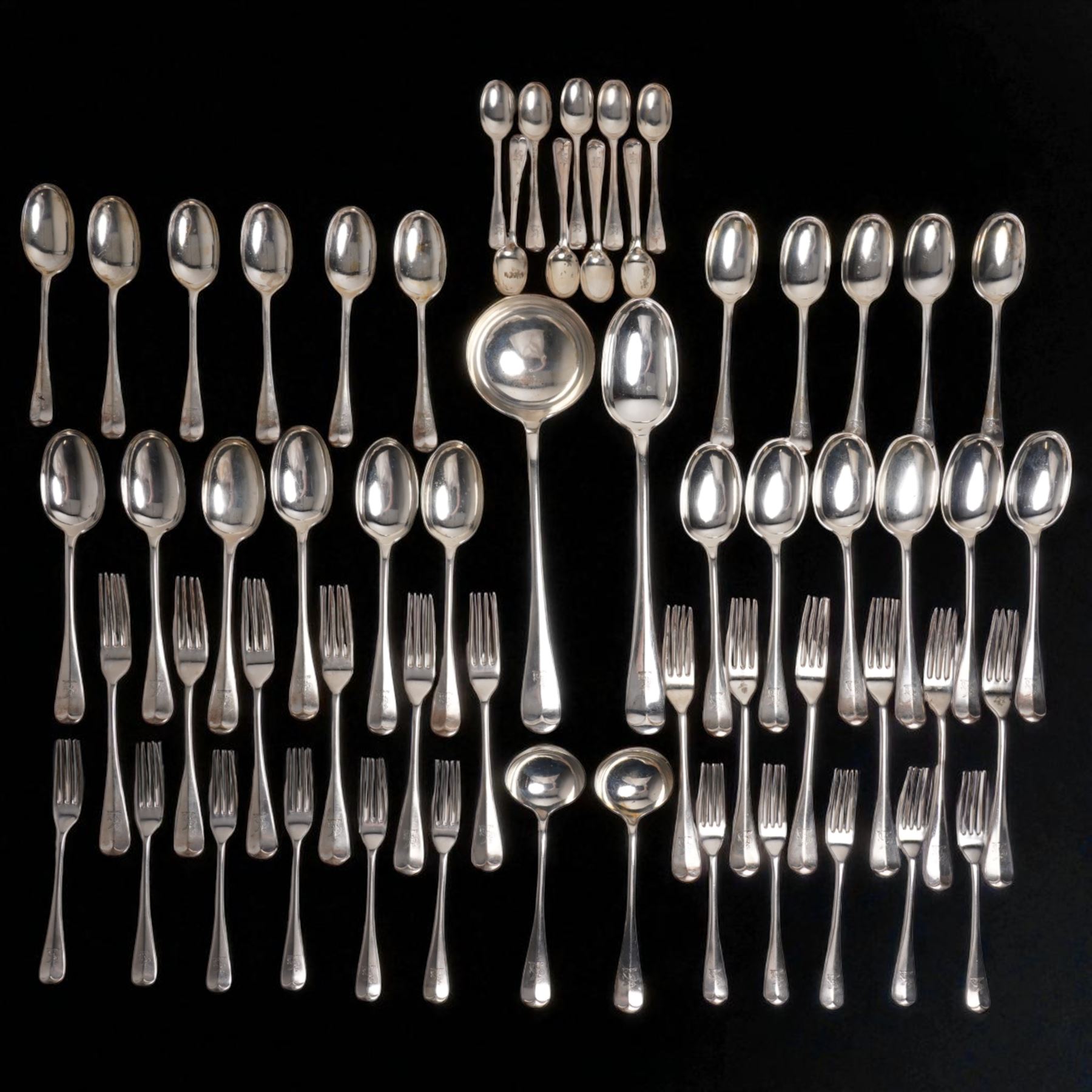 Suite of Edwardian silver rat tail cutlery engraved with a crest comprising twelve table forks, eleven dessert forks, twelve table spoons, eleven dessert spoons, nine teaspoons, soup ladle, pair of sauce ladles and basting spoon Sheffield 1901/02 Maker John Round & Son Ltd