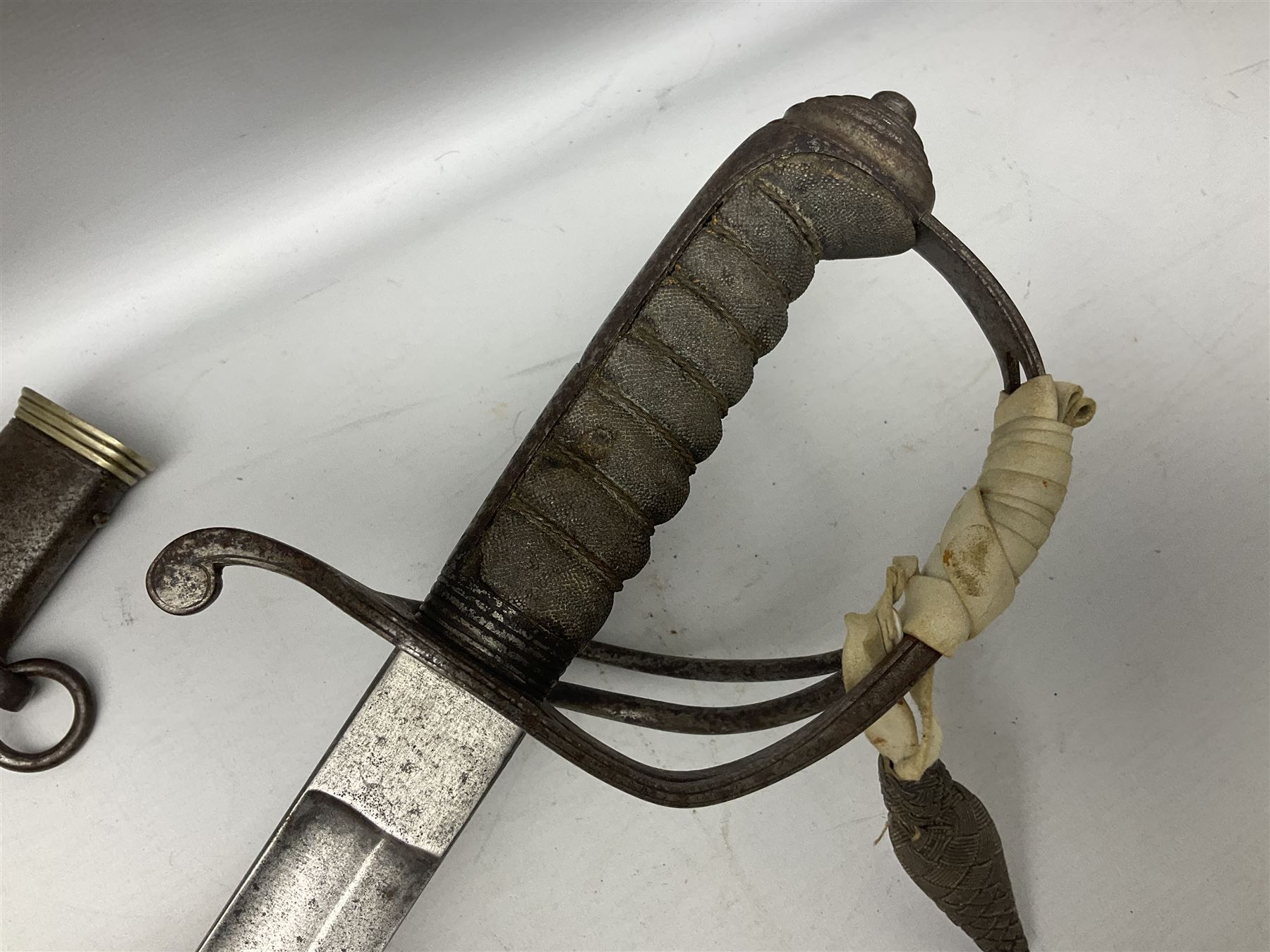 British 1821 Pattern Light Cavalry Officer's sword, with plain 87.5cm slightly curving fullered steel blade and plain steel three-bar hilt with wire-bound fish skin grip and plaited knot on later cord; in steel scabbard with two hanging rings L103cm overall