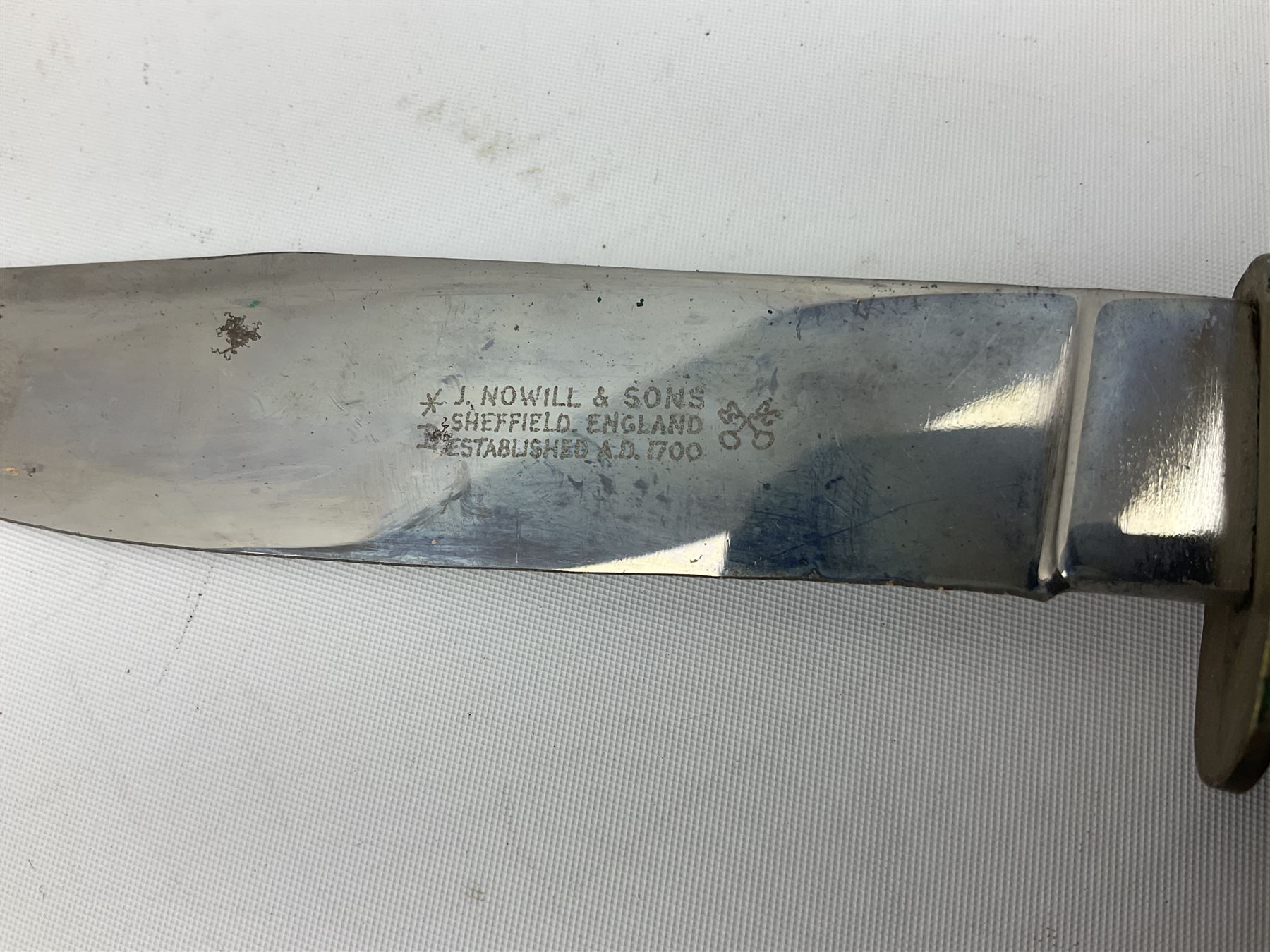 Graduated set of three Bowie knives by J. Nowill & Sons Sheffield England Est. AD1700, each with steel blade, brass cross-piece, stacked leather type grip and alloy pommel; largest blade 13cm and smallest 7.5cm; each in leather sheath (3)