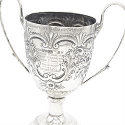 Edwardian silver twin handled trophy, engraved with presentation engraving and embossed with floral and foliate decoration to body, upon a domed circular weighted base, hallmarked 	Hammond, Creake & Co (Saint Arnaud Creake), Sheffield 1902, H22cm